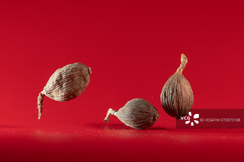 红色背景中飞舞的草果图片素材