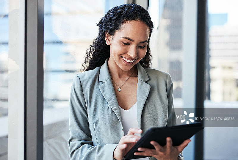 年轻女商人在办公室使用平板电脑图片素材