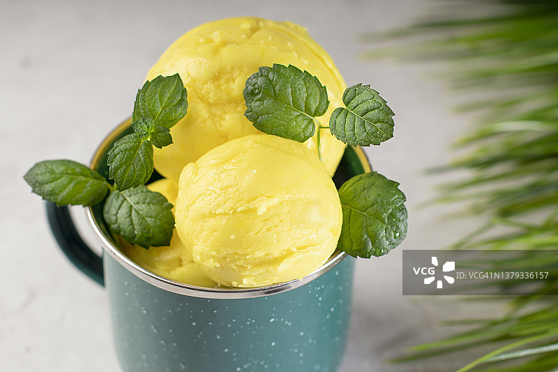 自制黄色水果冰淇淋球，配新鲜薄荷图片素材