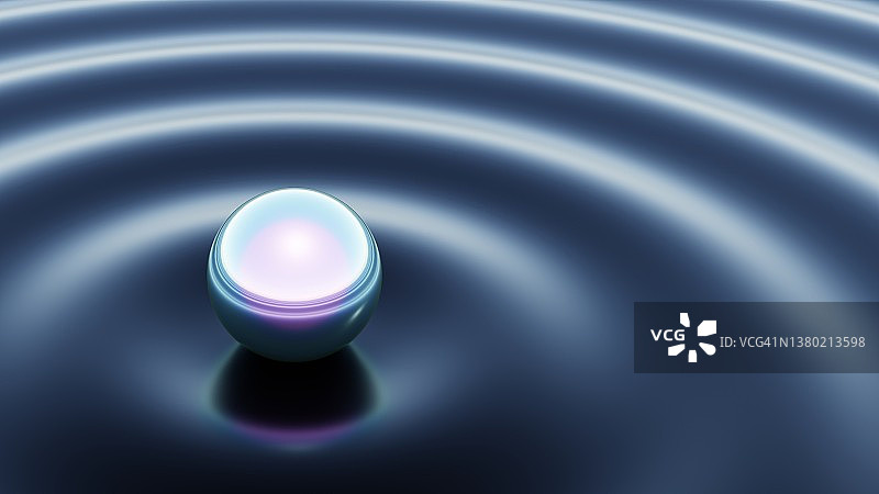 接触液体表面并产生涟漪的彩虹色球体图片素材