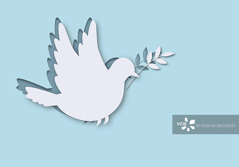 蓝天下飞翔的衔着橄榄枝的白色鸽子，世界和平日概念图片素材