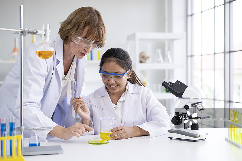 女学生和老师进行化学实验图片素材