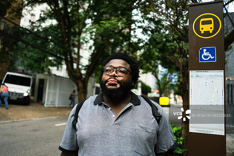 患有白癜风的工人在等公共汽车图片素材