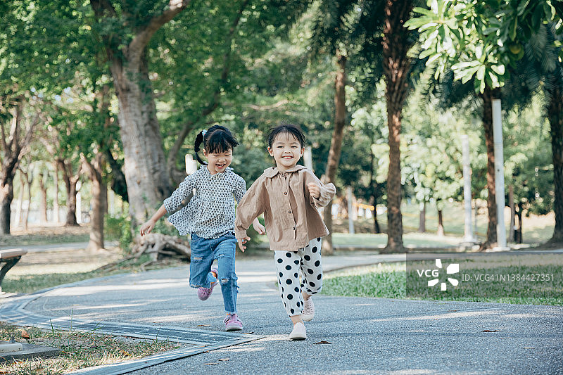 亚洲儿童姐妹在公园里玩耍图片素材