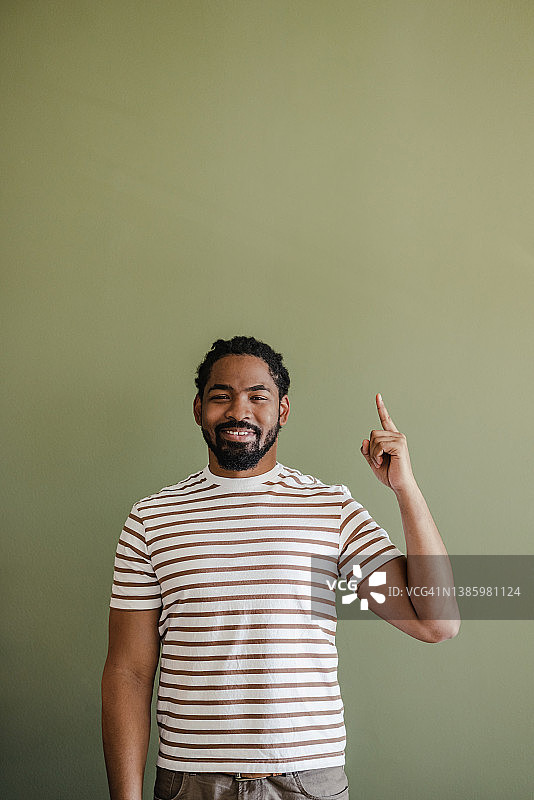 影棚拍摄：举起食指的非洲裔美国男人图片素材