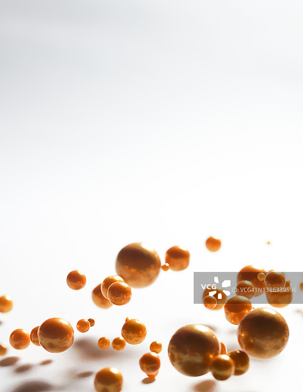 白色背景中不同大小的金色球体漂浮图片素材