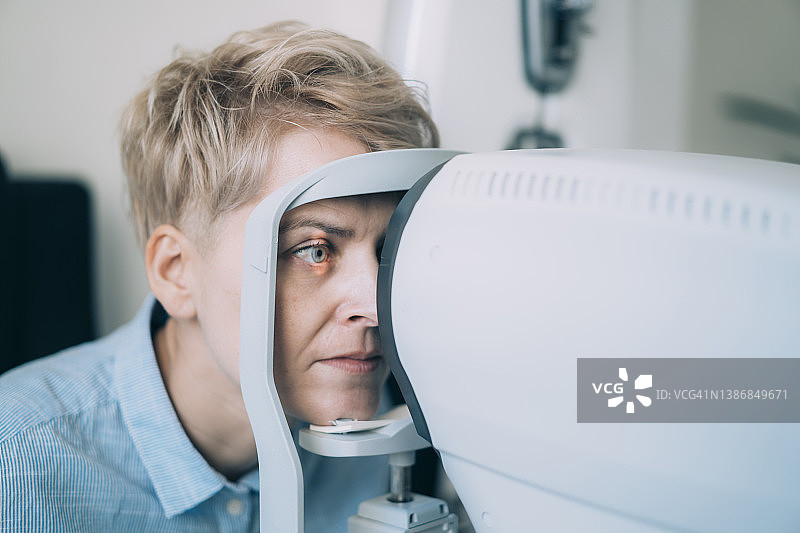 女人注视验光仪的特写镜头图片素材