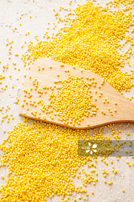 木勺和桌子上生小米的特写，顶视图图片素材