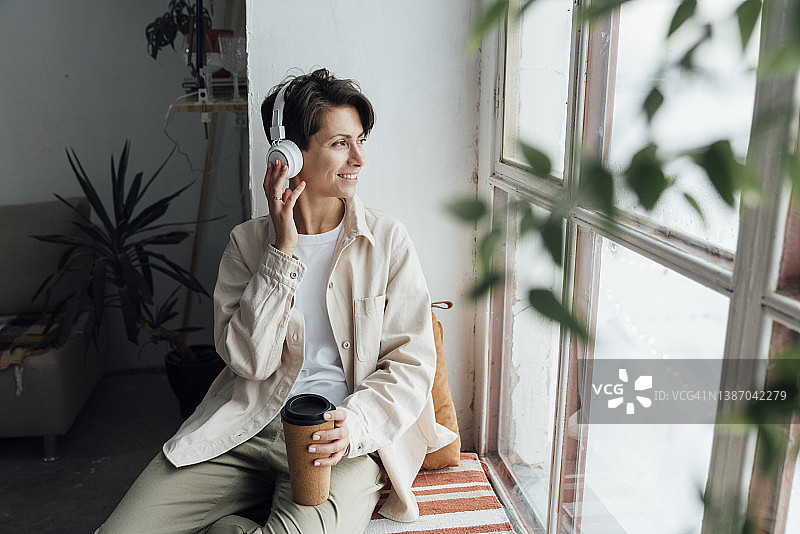 戴耳机听音乐的微笑女人图片素材