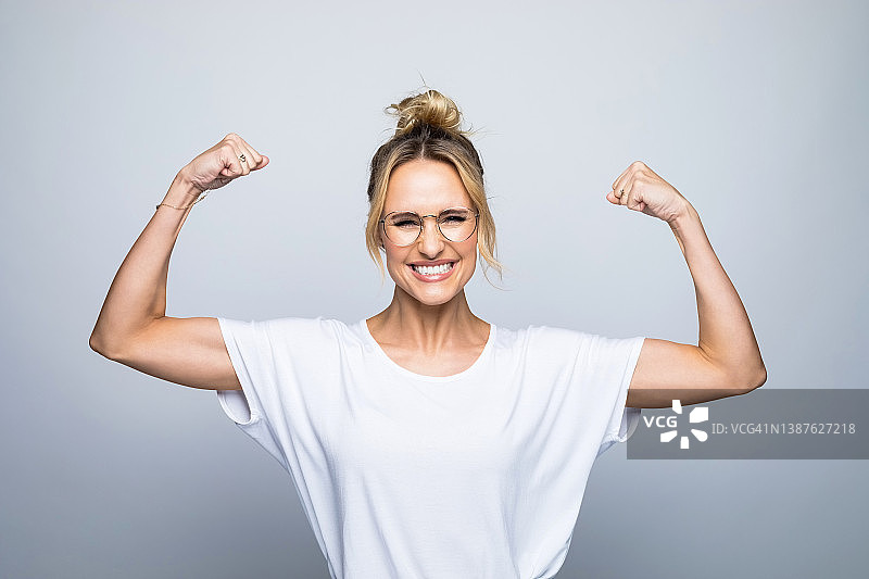 展示肌肉的快乐美丽女子肖像图片素材