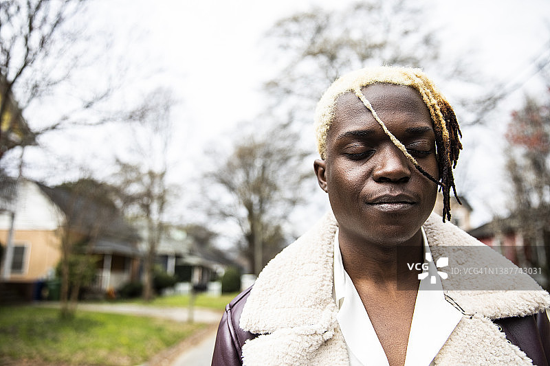 城市住宅区里的时尚青年男子肖像图片素材