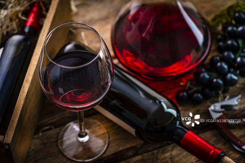 乡村餐桌上的红酒瓶、酒杯和醒酒器图片素材