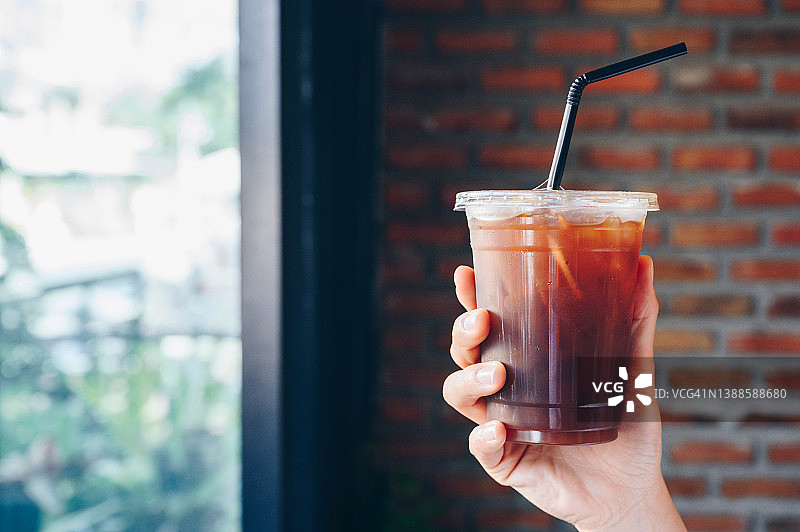 手持冰美式咖啡塑料杯图片素材