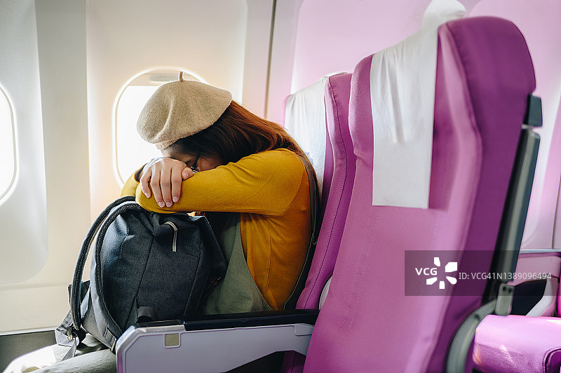 长途飞行中在飞机上睡觉/小憩的游客图片素材