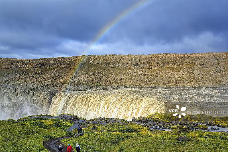 前往黛提瀑布的路上徒步者，冰岛北部，河水倾泻而下，彩虹图片素材