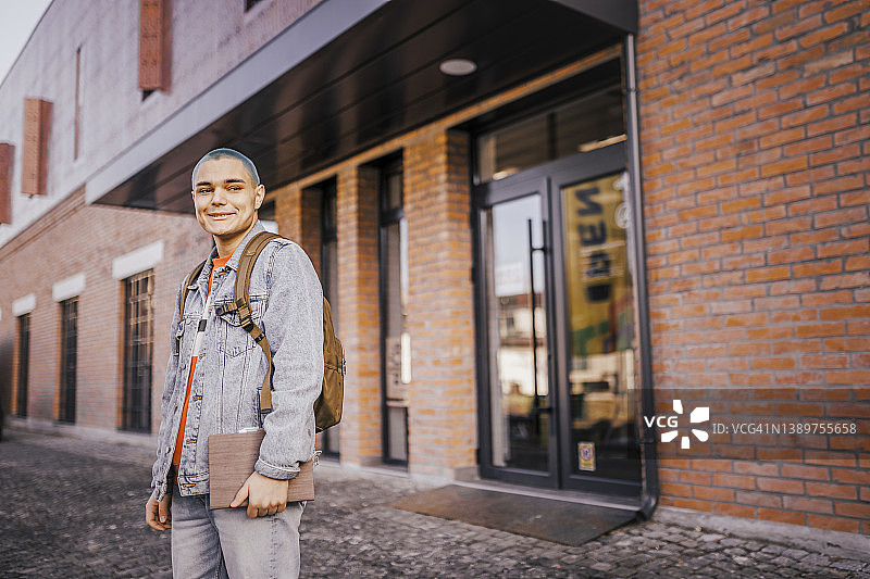 城市街道上的微笑学生肖像图片素材