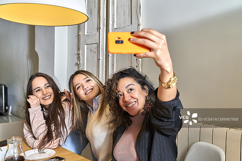 三位女人在餐桌旁自拍图片素材