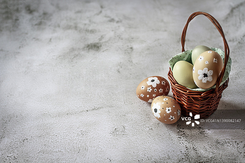 混凝土桌上的复活节彩蛋篮子，留白区域，贺卡图片素材