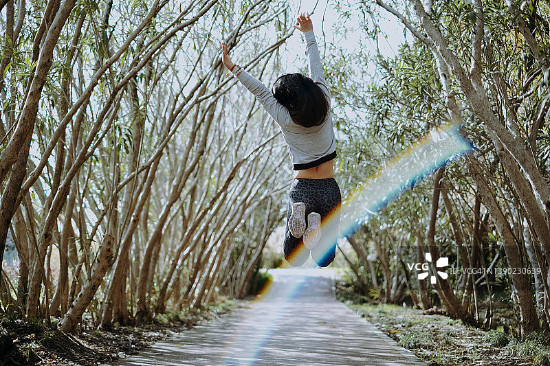 在森林中跳跃的女人图片素材
