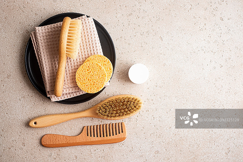 环保身体护理用品套装（木制身体刷、清洁手套、清洁海绵、精华液瓶、发刷、保湿霜）和可重复使用的网袋图片素材