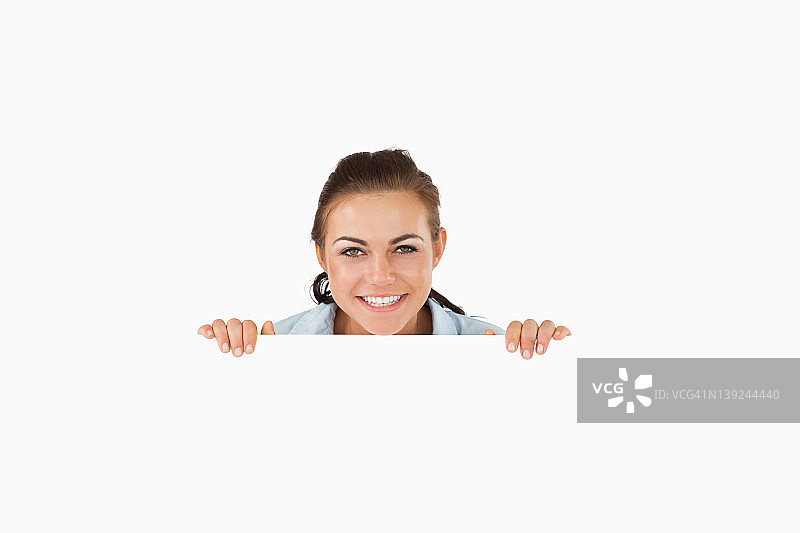 微笑的女商人越过墙壁图片素材