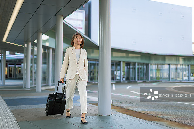 商务旅行中走过车站的女商人图片素材