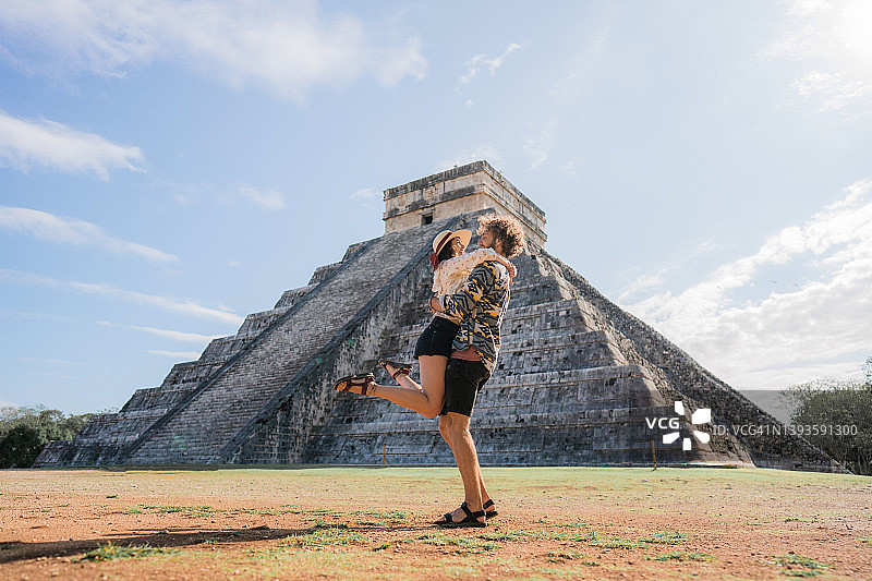 情侣在墨西哥奇琴伊察金字塔的背景下图片素材