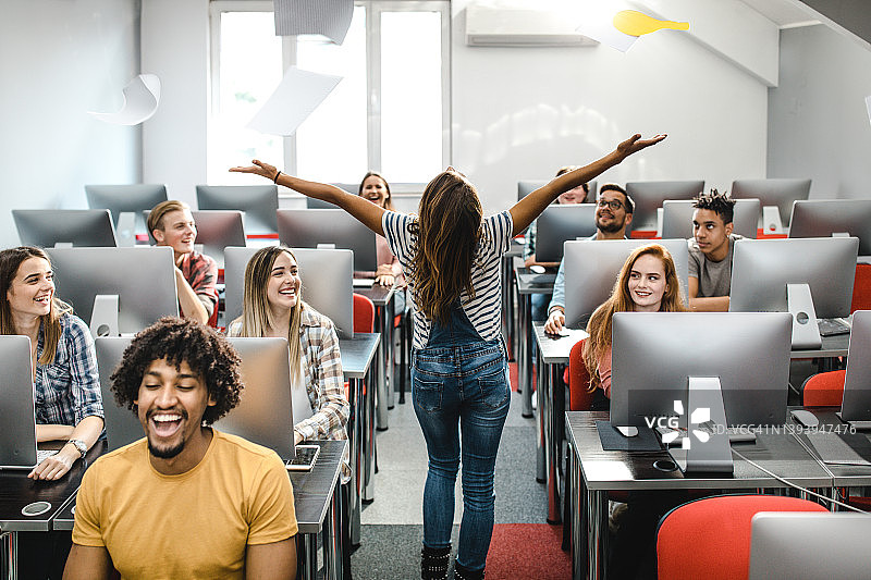 在电脑实验室娱乐同学的快乐女学生背影图片素材
