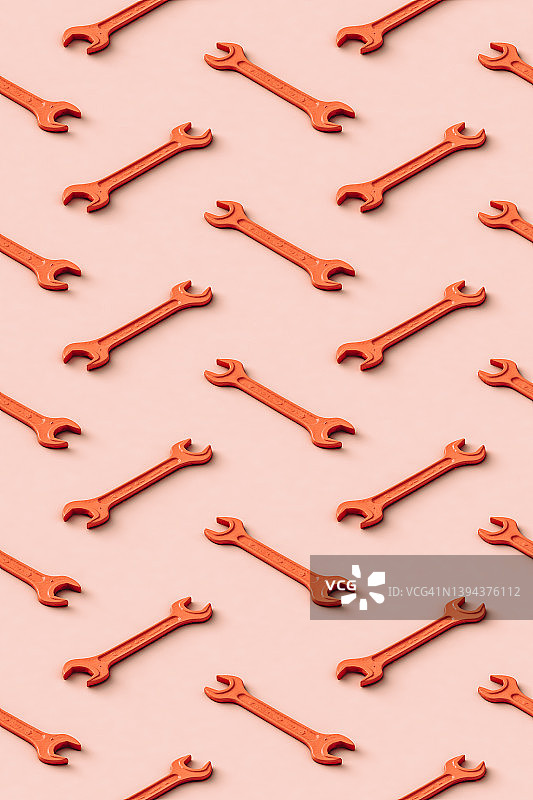 橙色扳手行平铺于米色背景上的3D图案图片素材
