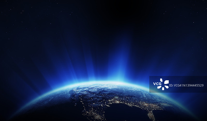 从太空看地球：北美洲位于地球的夜晚面，旭日东升并伴有镜头光晕图片素材