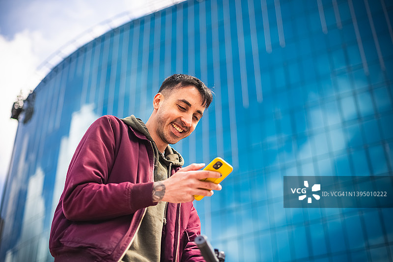 年轻男人在城市里使用手机图片素材
