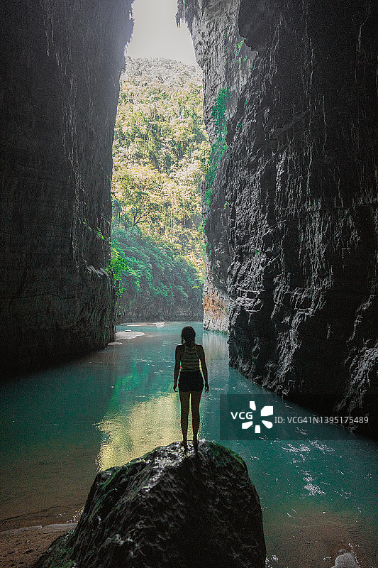 站在墨西哥恰帕斯州时间拱门岩石和绿松石河上的女人图片素材