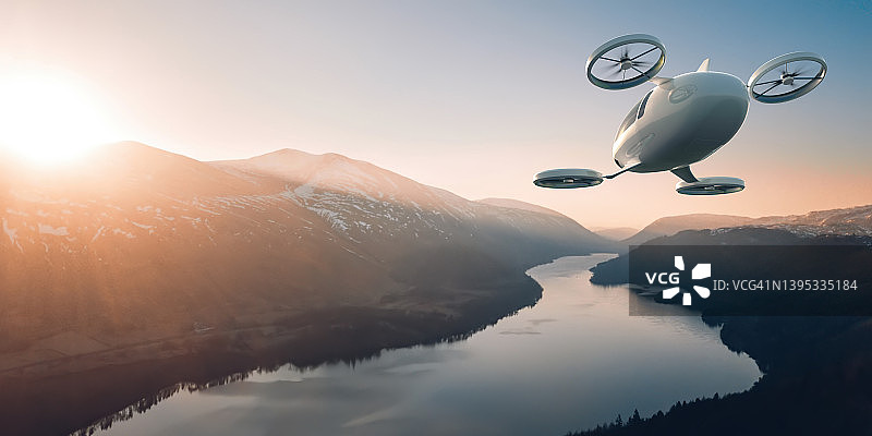 电动垂直起降飞行器在黎明时分飞越美丽风景图片素材