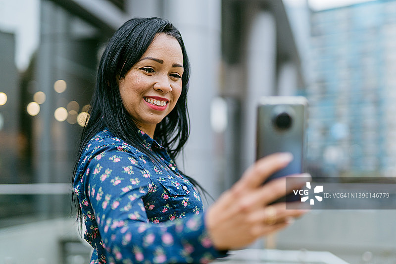女商人在城市中使用智能手机图片素材