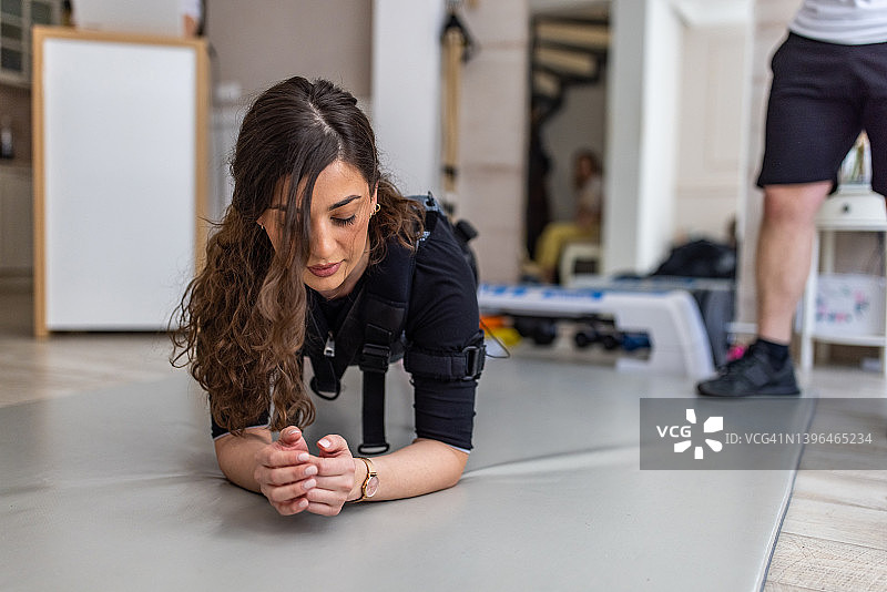 接受EMS锻炼的白人女客户图片素材