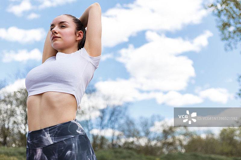 女孩正在做肩部伸展运动。图片素材