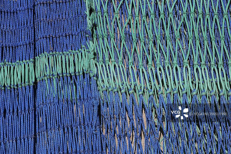 西班牙，带有绿色和蓝色绳索的渔网图片素材