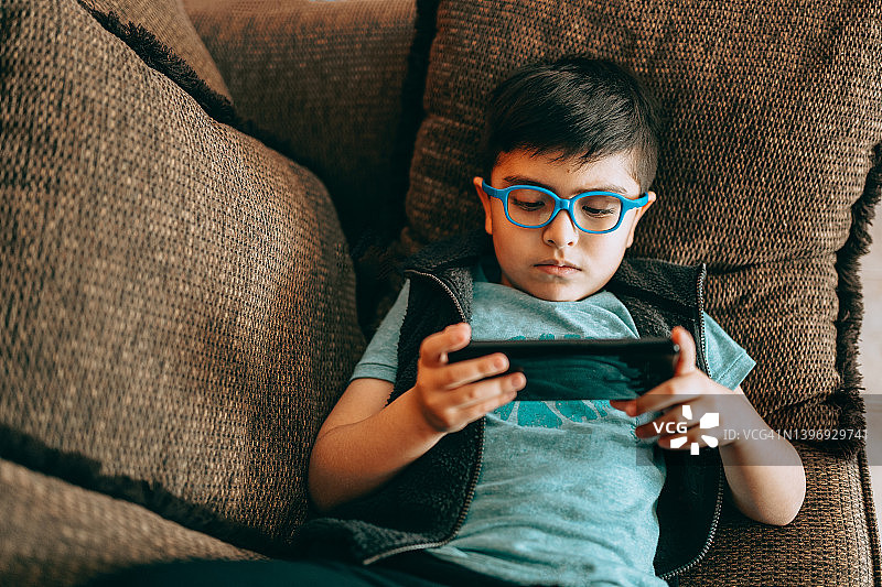 男孩用手机观看视频图片素材