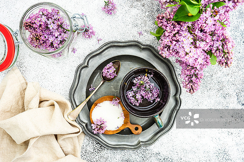茶杯、糖碗和新鲜丁香花俯视图图片素材