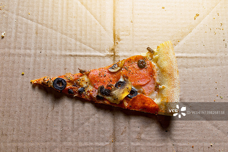 美味的意大利披萨：外卖披萨盒装，白色背景。番茄、意大利辣香肠、培根和奶酪披萨切片，不健康的生活方式快餐理念。图片素材