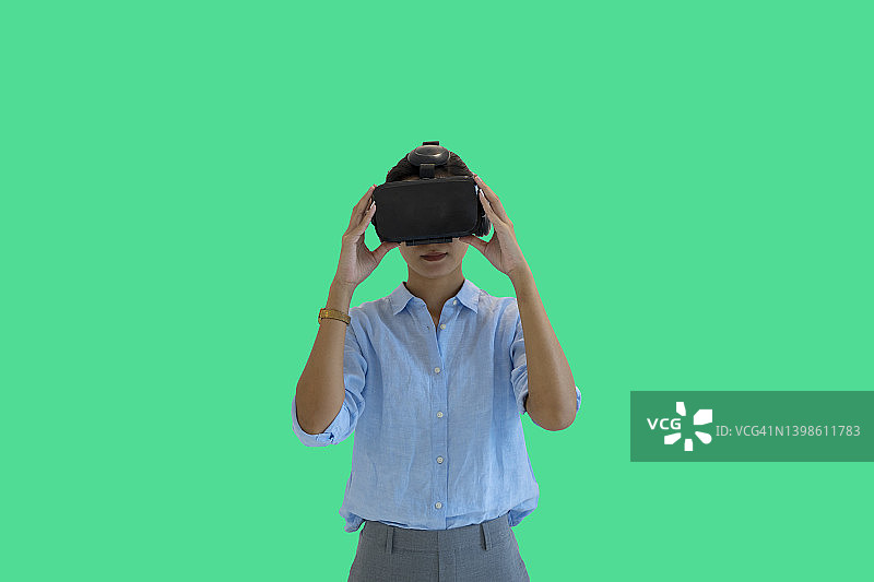 身穿蓝色衬衫、戴VR眼镜的女子图片素材