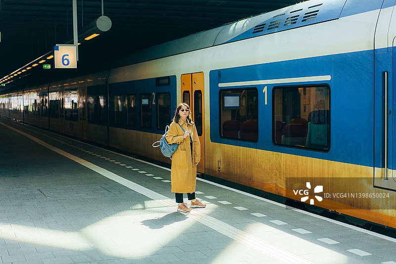 在火车站等火车时打电话的女人图片素材