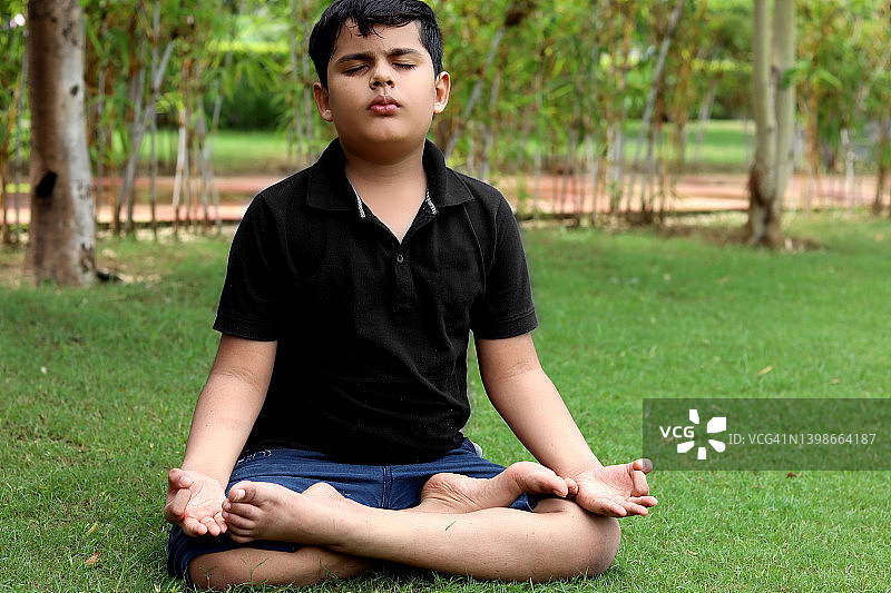 孩子在公园里练习瑜伽图片素材