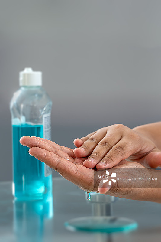 使用酒精搓手液的女人：预防冠状病毒传播，保持手部清洁图片素材