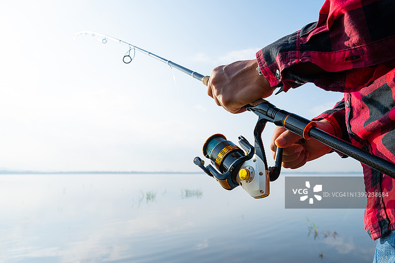 男人在湖边钓鱼特写图片素材