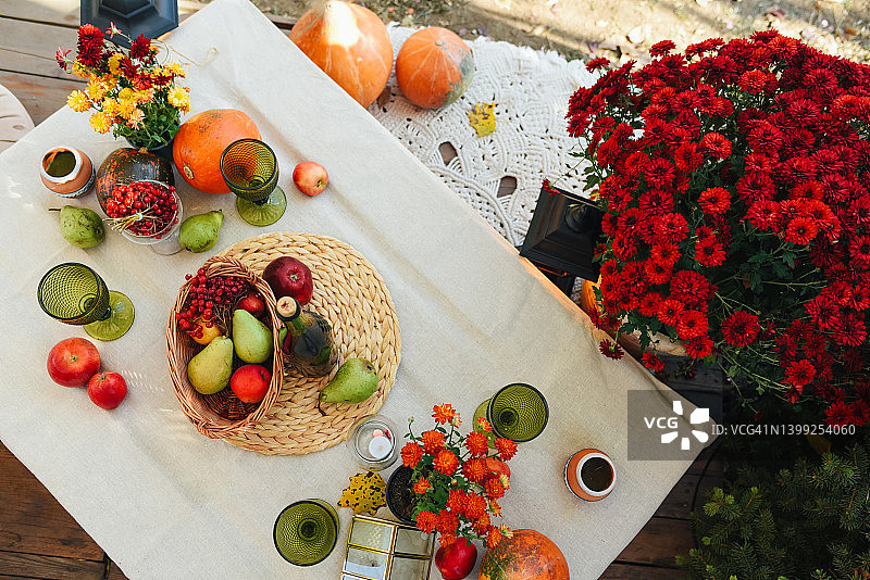 用秋季主题元素装饰的时尚餐桌：秋季水果和丰收图片素材