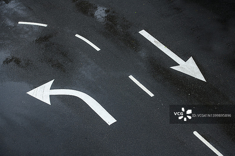 沥青路面上向左转和直行白色箭头指示牌图片素材