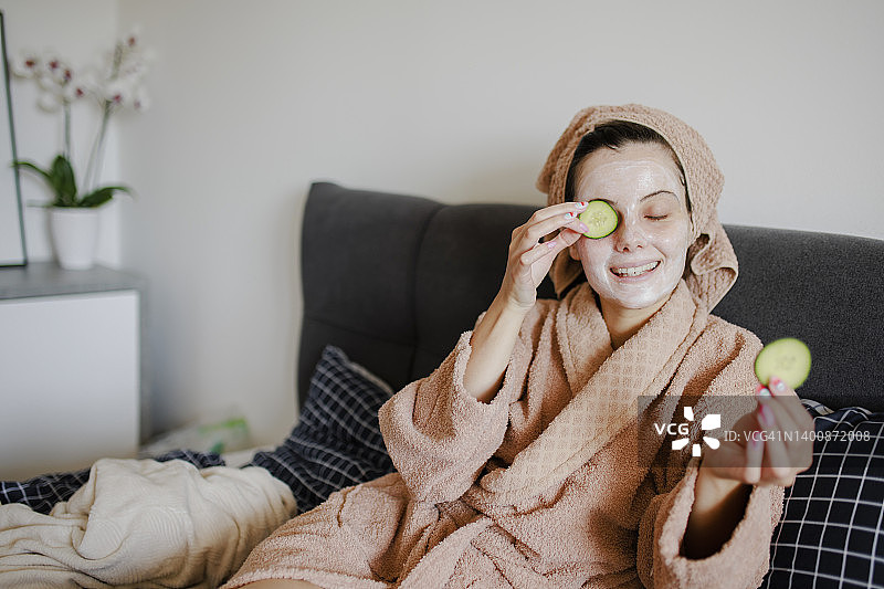 女性在床上进行皮肤护理图片素材
