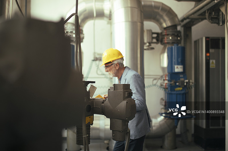 在发电厂巡视的严肃的劳动监察员图片素材