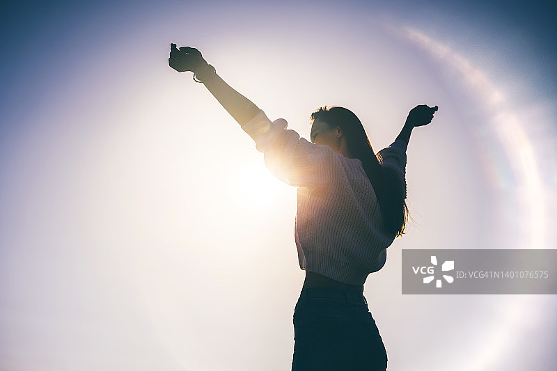 夕阳下的快乐女人剪影图片素材